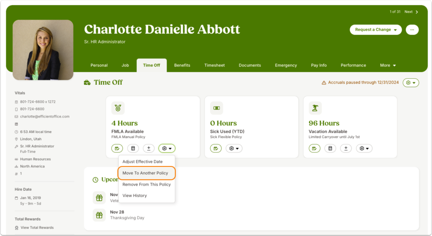 Screenshot of an employee profile under the Time Off tab. The employee name and job details are displayed at the top. Three time off categories are shown: FMLA Available, Sick Used, and Vacation Available, each with balances displayed in hours. A dropdown menu is open under one category, showing options such as “Adjust Effective Date” and “Move to Another Policy.” A highlighted selection emphasizes “Move to Another Policy.”