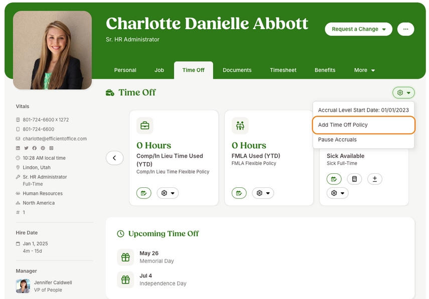 Screenshot of an employee profile in BambooHR with the Time Off tab open. The page header shows the employee’s information and page tabs. In the main section, time off balances are shown in tiles, with an Upcoming Time Off list below. In the top-right gear menu, the dropdown shows the accrual level start date of 01/01/2023 along with two other options. The “Add Time Off Policy” option is highlighted with an orange outline, indicating the action point.