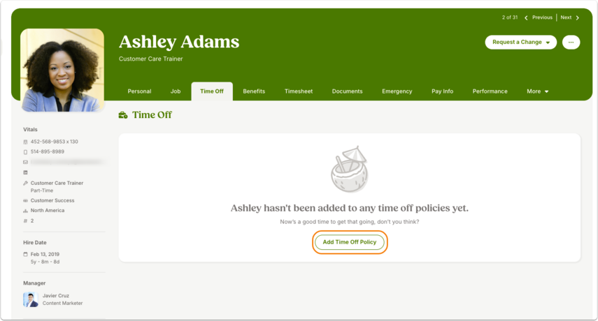 Screenshot of an employee profile with a green header. The Time Off tab is selected. The main panel displays the message: “This employee hasn’t been added to any time off policies yet. Now’s a good time to get that going, don’t you think?” Below is a button outlined in orange labeled Add Time Off Policy.
