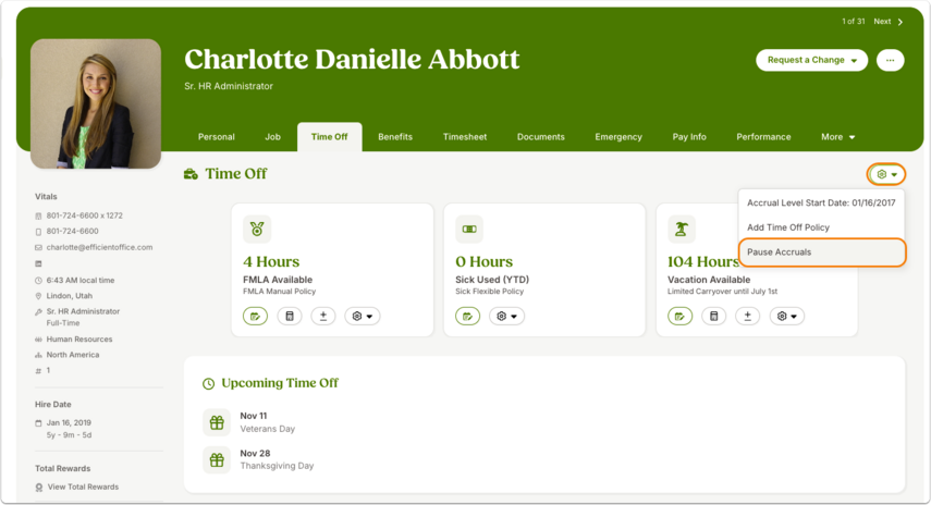 Screenshot of an employee’s profile on the Time Off tab. A gear icon menu is open, with Pause Accruals highlighted.