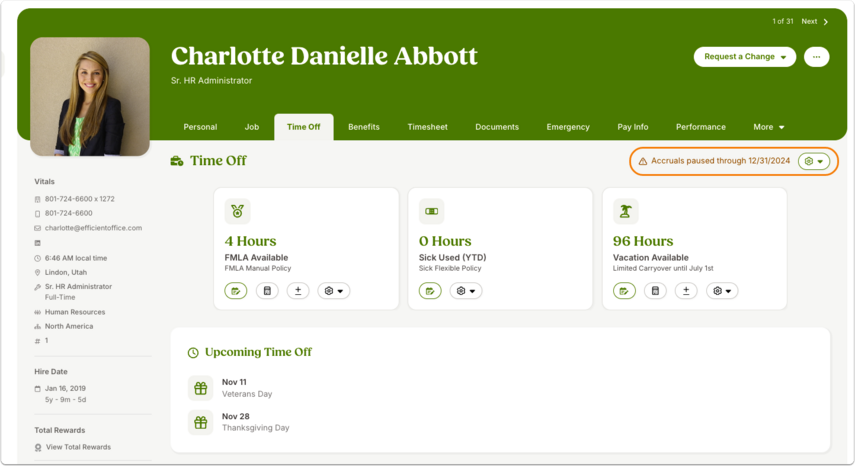 Employee’s Time Off tab showing a red banner: accruals are paused through the listed date.