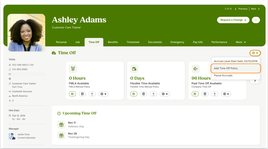 Screenshot of the Time Off tab. Three policy cards are displayed: FMLA Available – 0 Hours, Flexible Time Available – 0 Days, and Paid Time Off Available – 96 Hours. A dropdown menu on the Paid Time Off card is open with the option Add Time Off Policy outlined in orange.